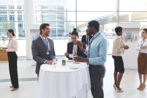 Young business professionals drinking and chatting at a networking event