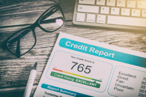 A credit report lying on desk with the number 765.