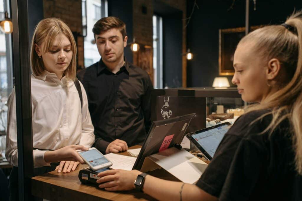Woman and man paying at the counter