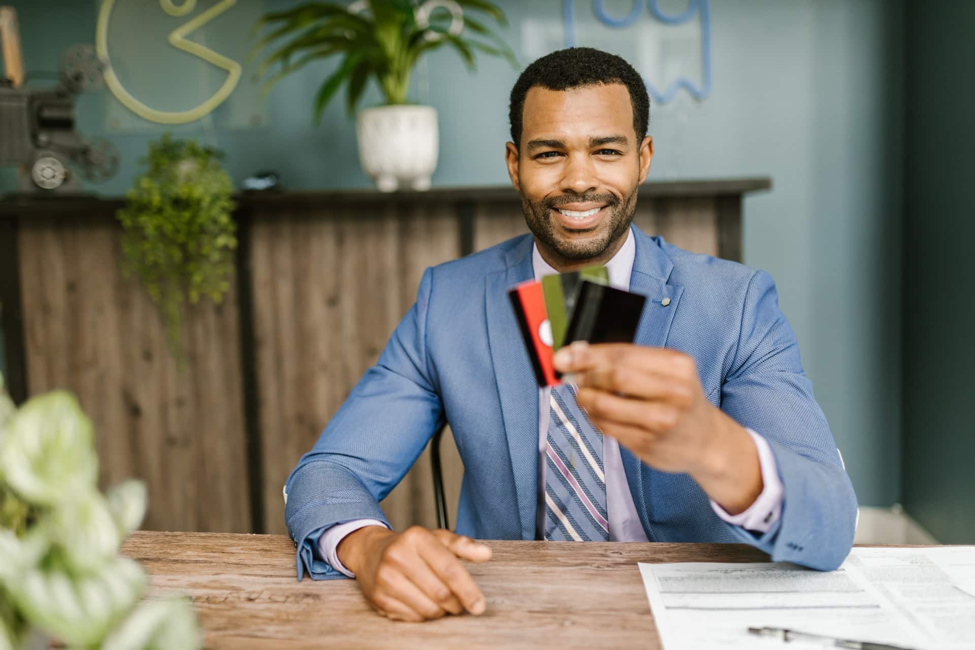 man holding three credit cards