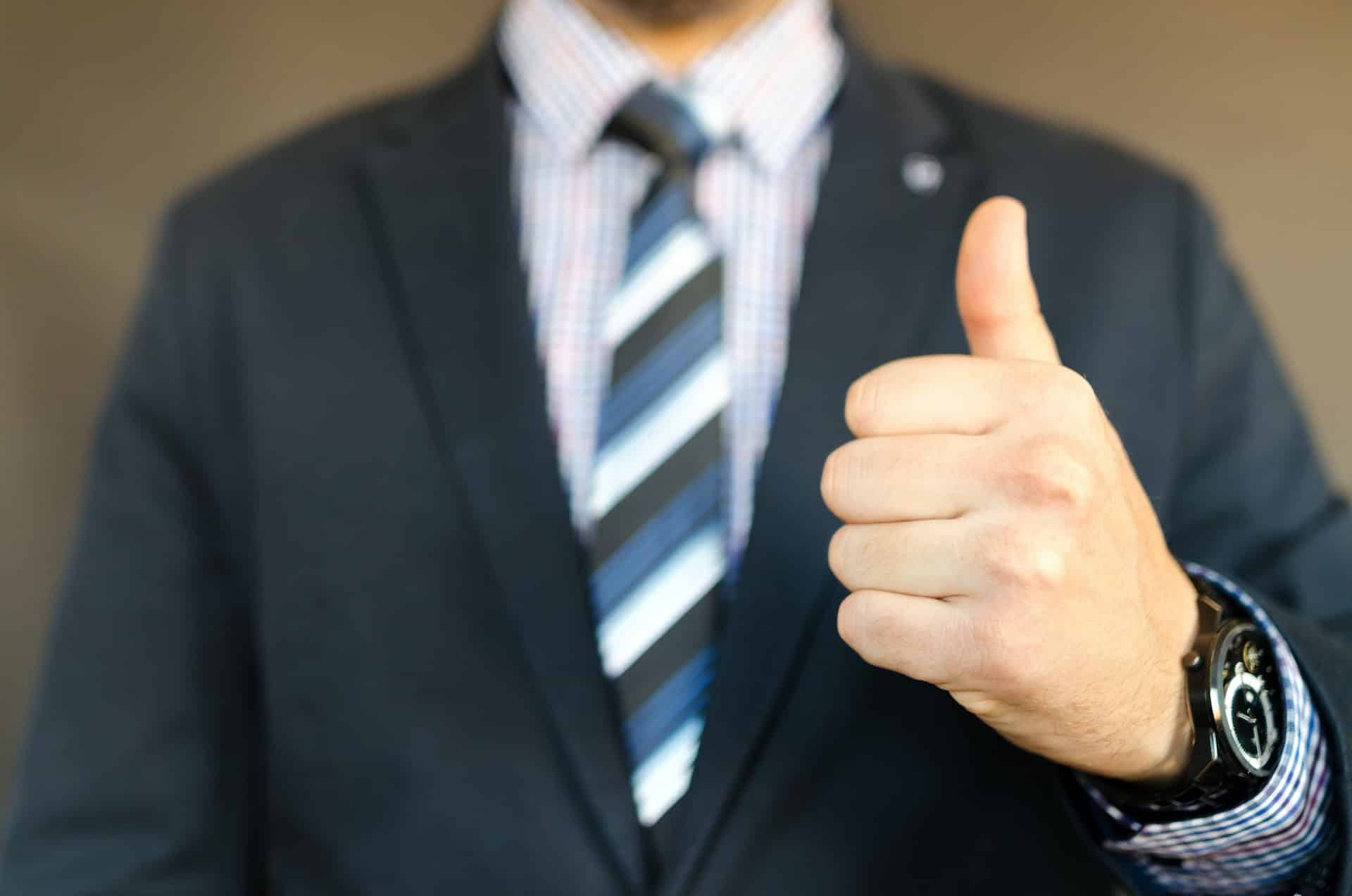 A businessman showing thumbs up