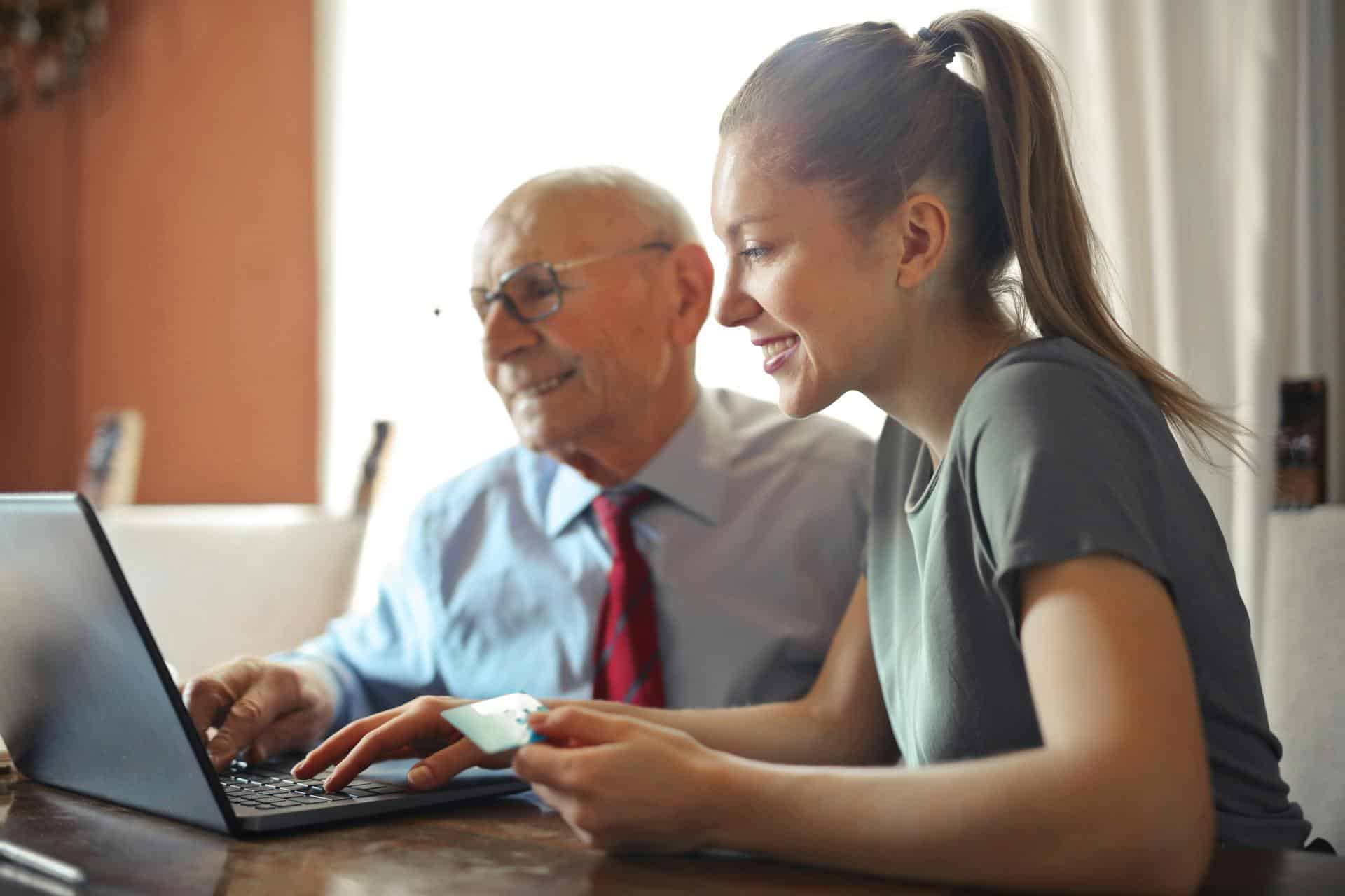 Young woman with senior on computer