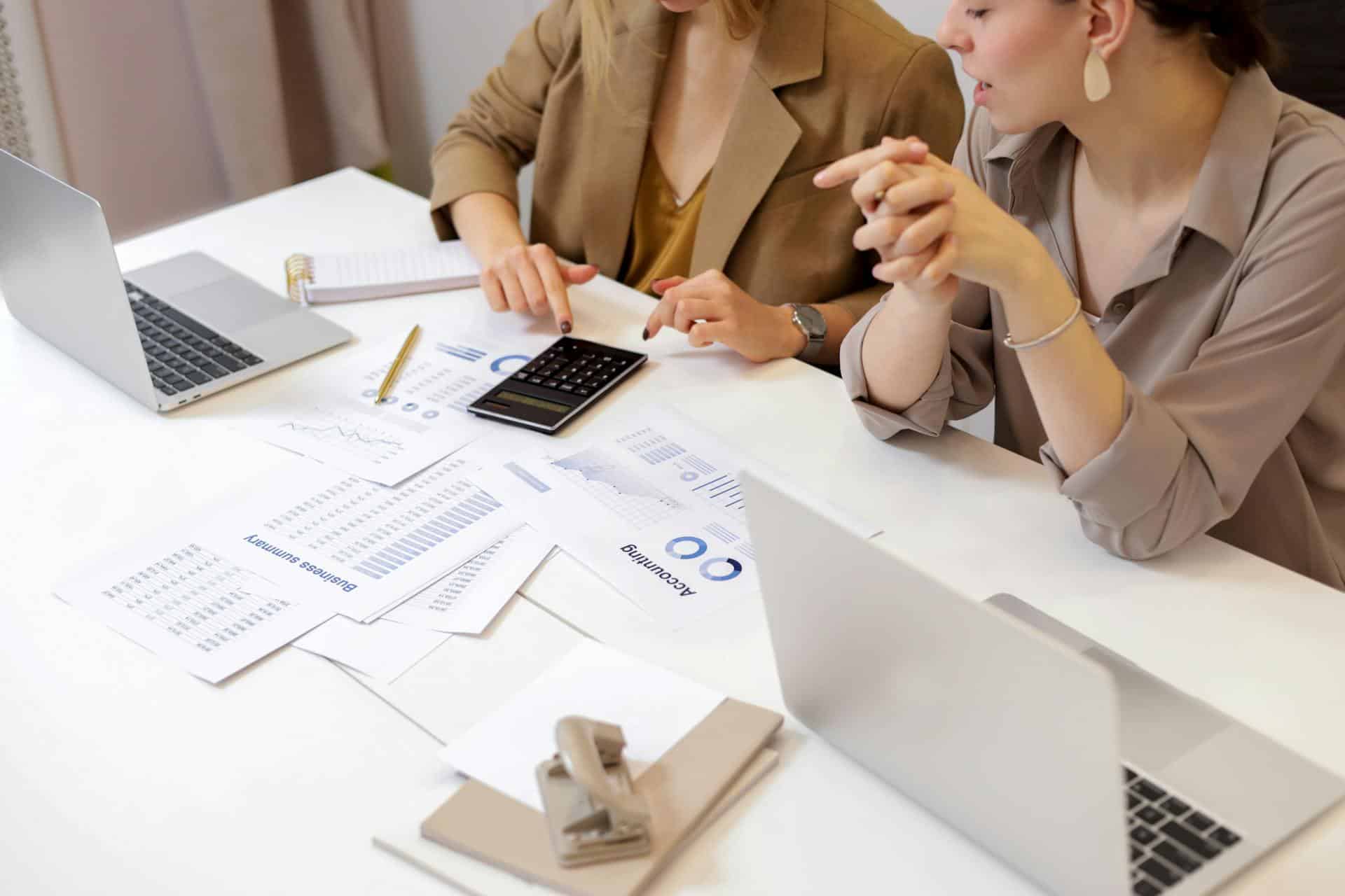 Two women looking at a calculator