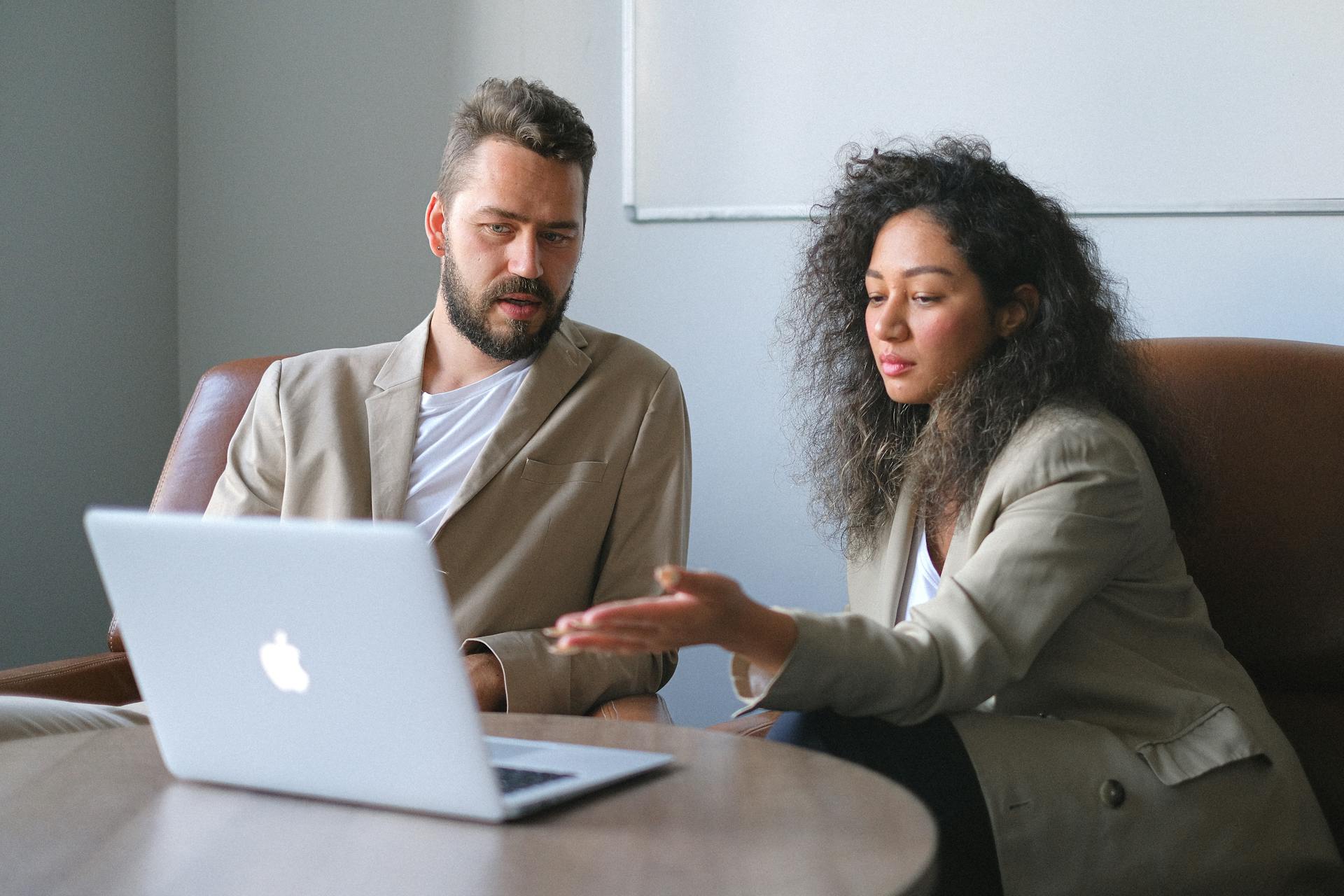 Man and woman looking at a laptop.