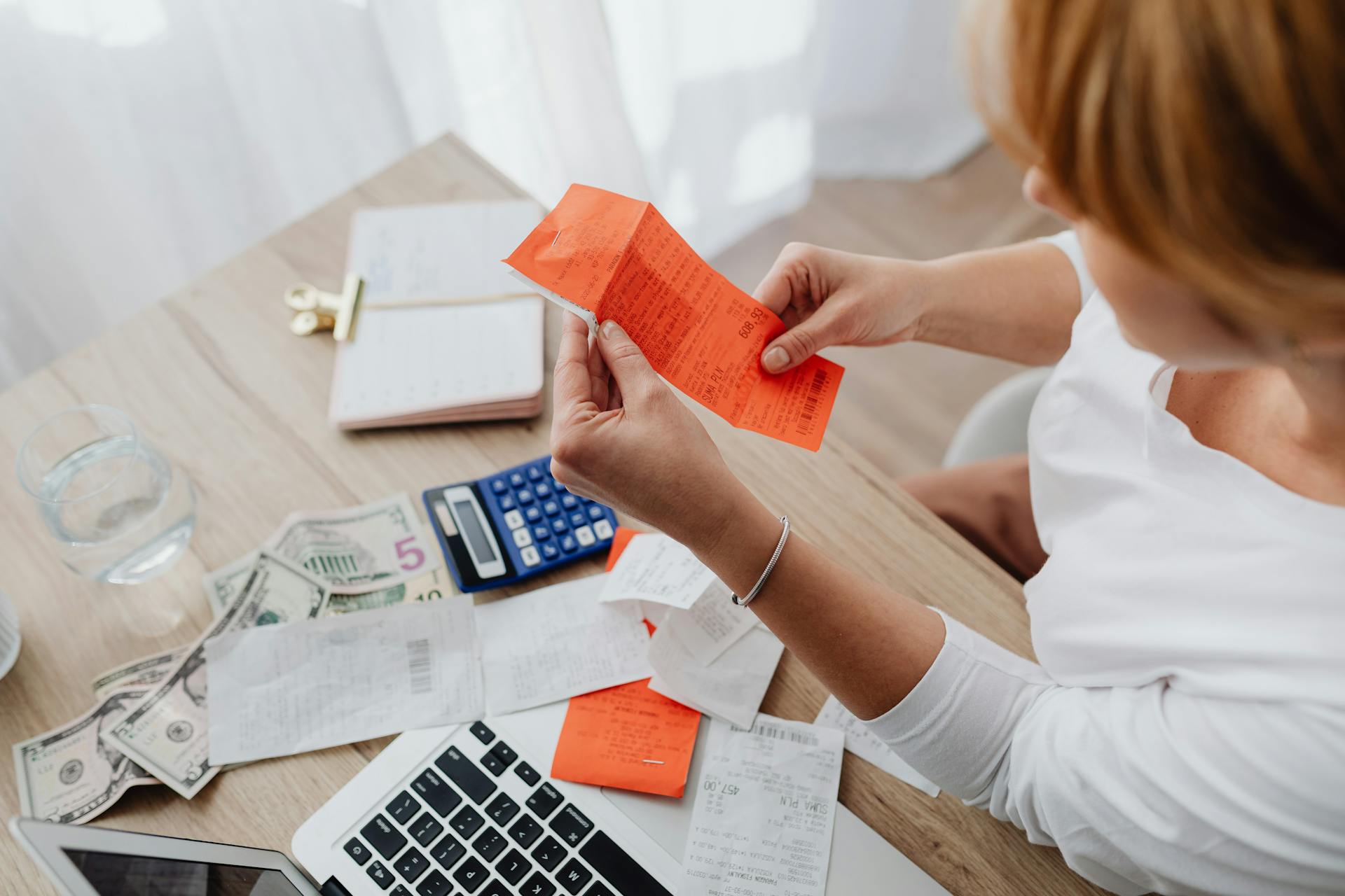 Woman sorting receipts and counting money