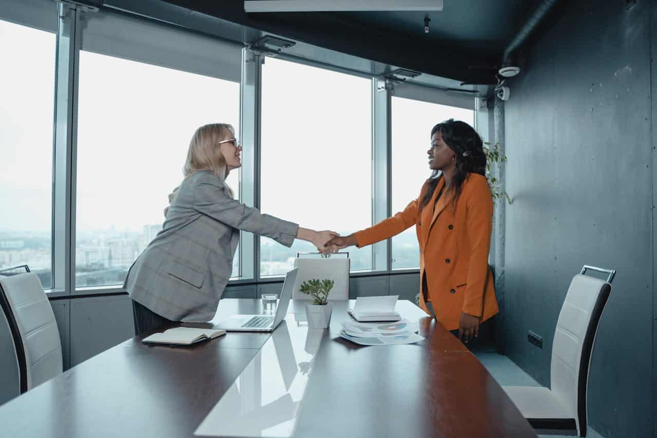 Two women shaking hands