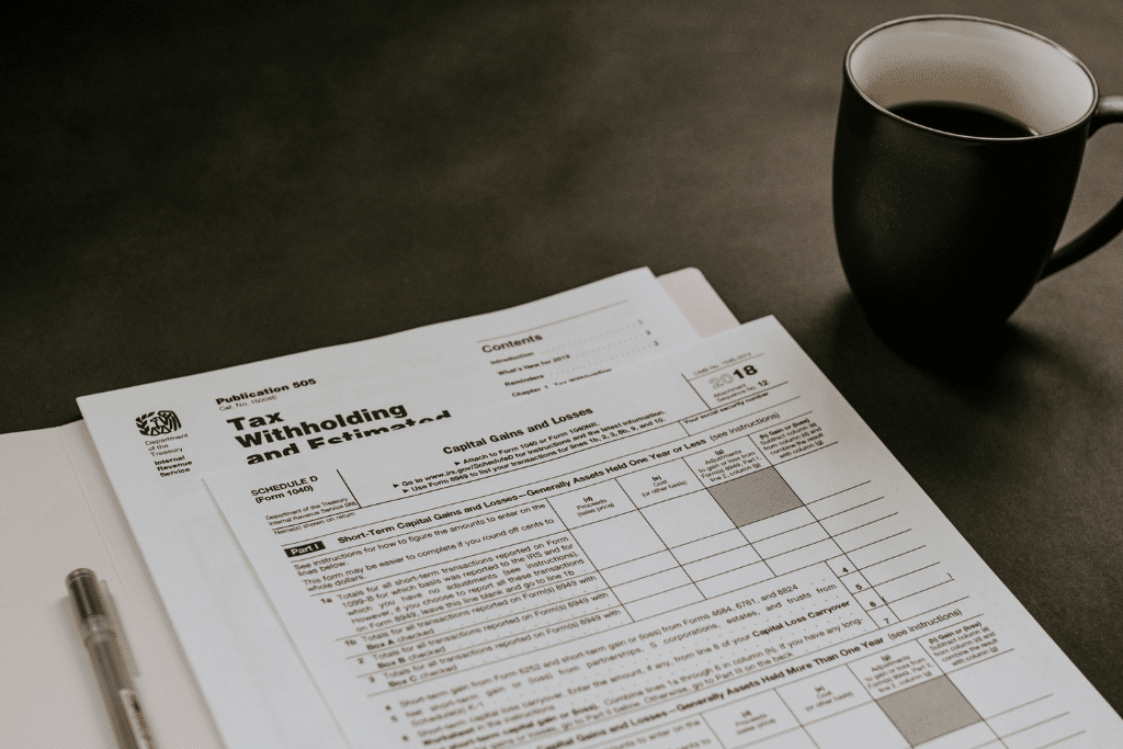 black ceramic mug beside white printer paper