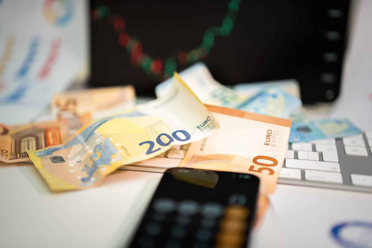 Household budget accounts and Euro currency banknotes on a table.