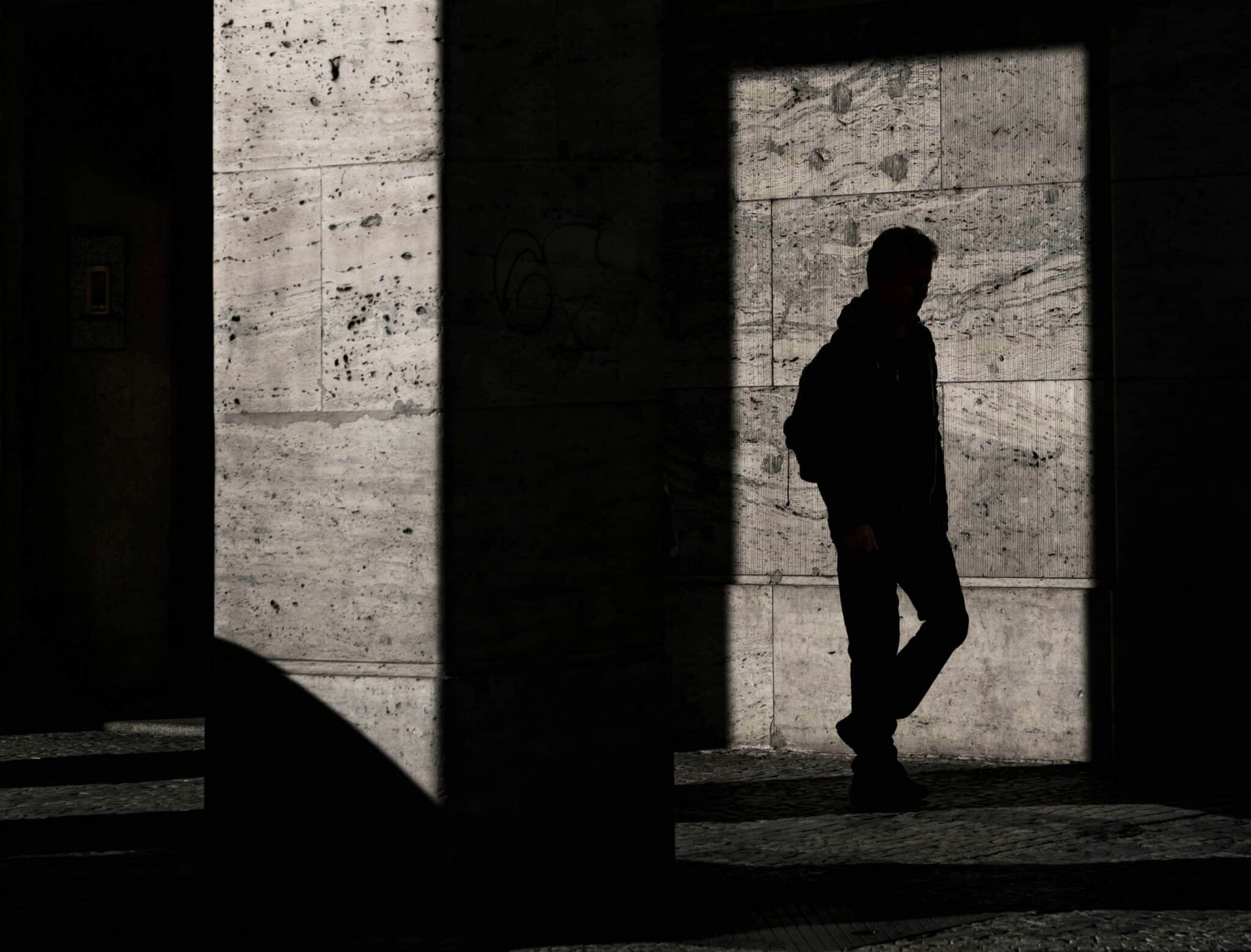 silhouette of man standing inside structure