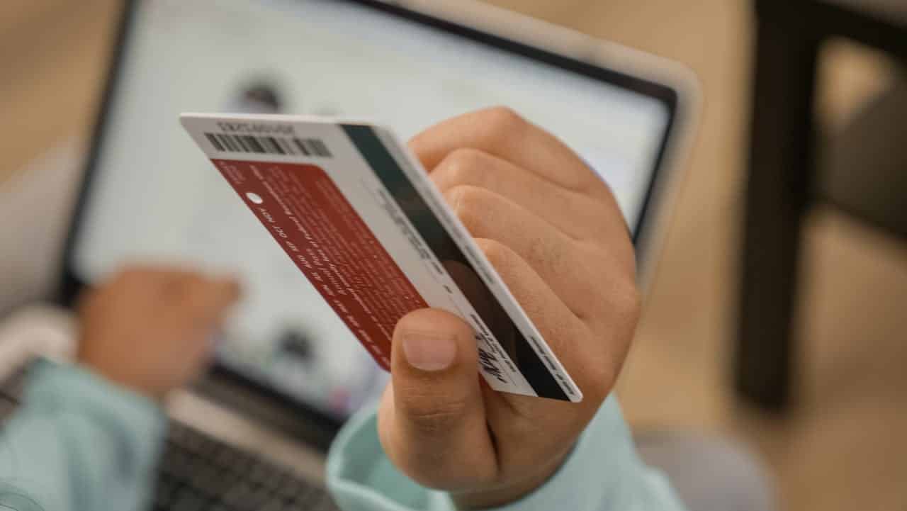 A person holding a credit card