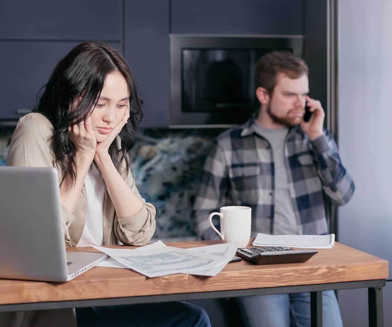 A confused couple looking at documents