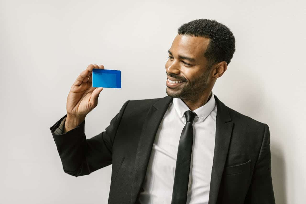 Businessman holding a blue credit card