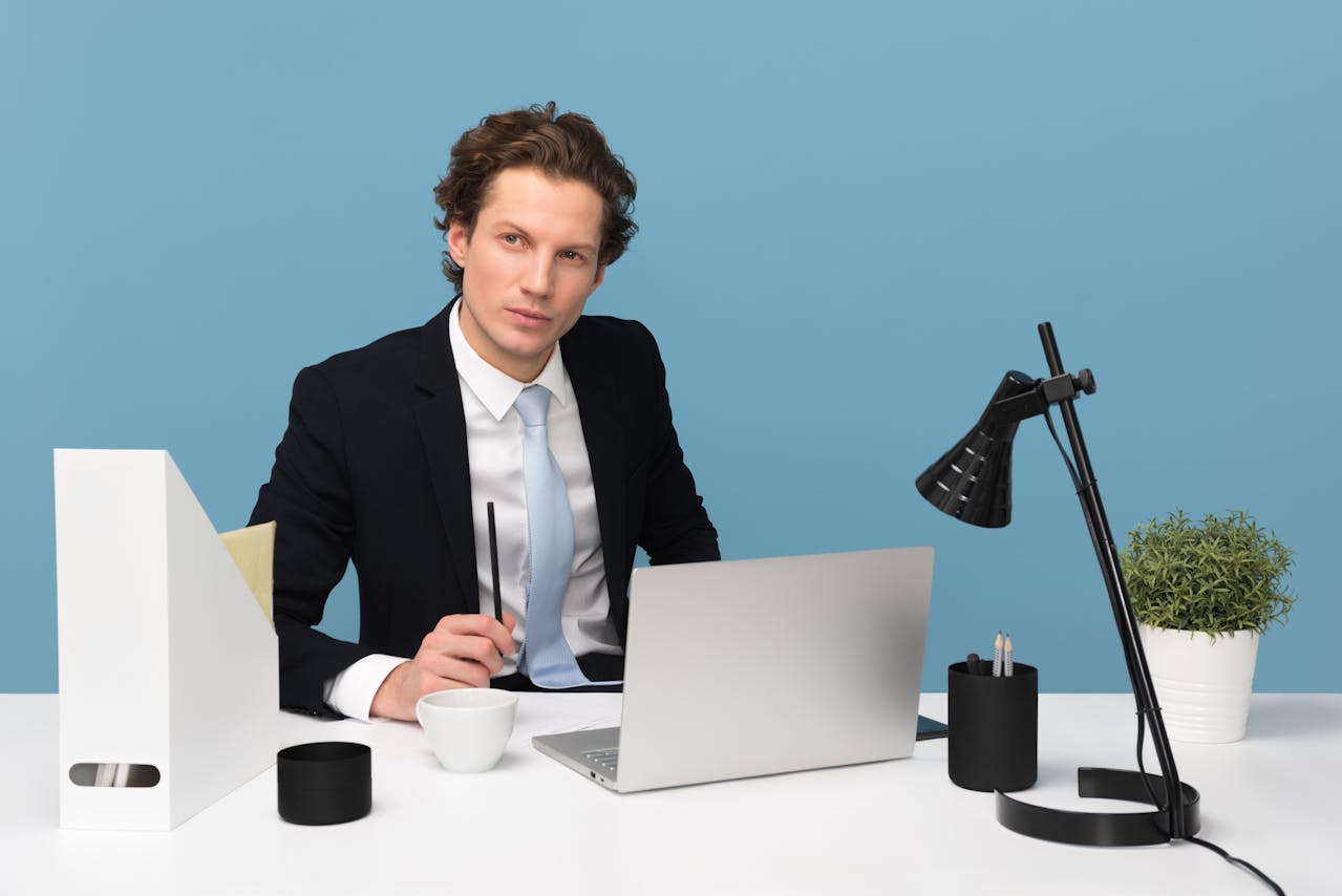 Businessman thinking while on a laptop
