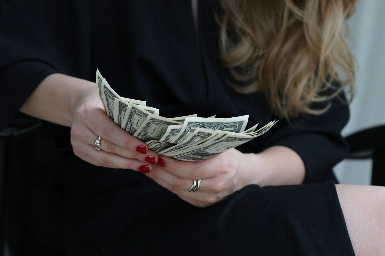 A woman counting dollar bills