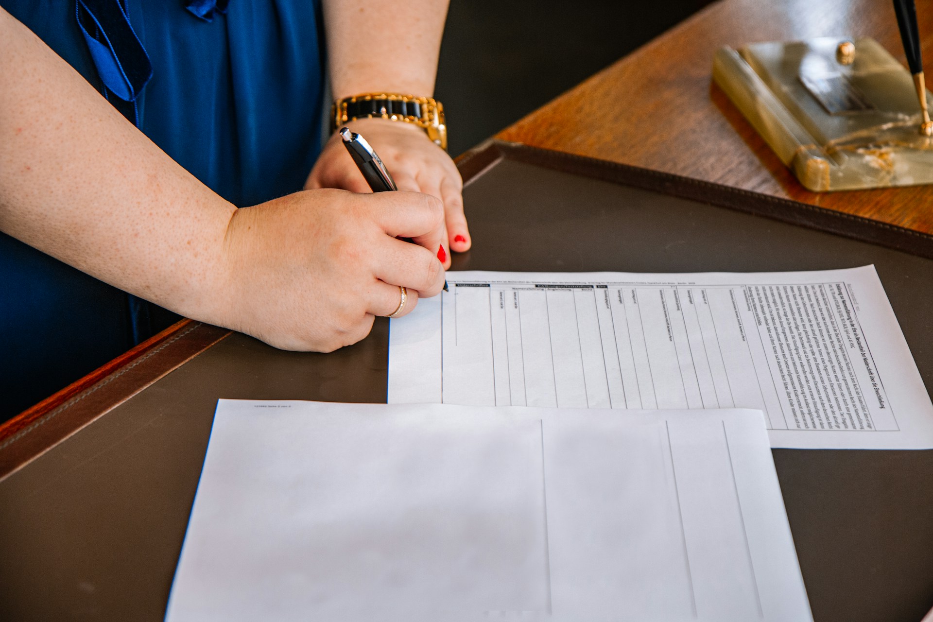 Close-up of a woman signing a contract