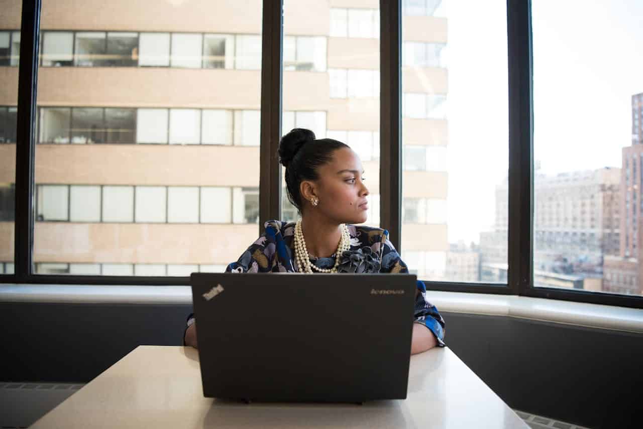 A woman looking at a building window