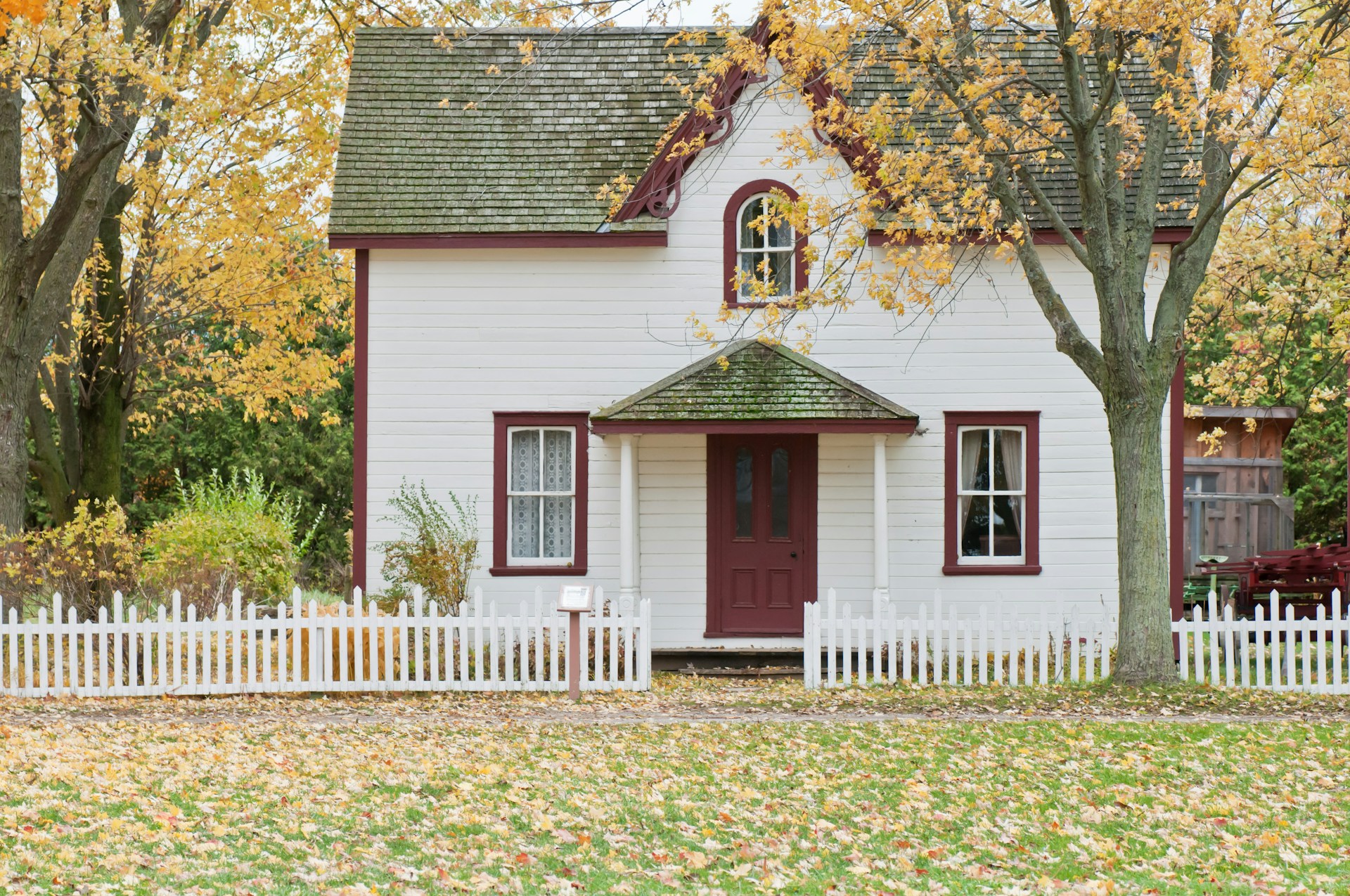A white house with trees around it