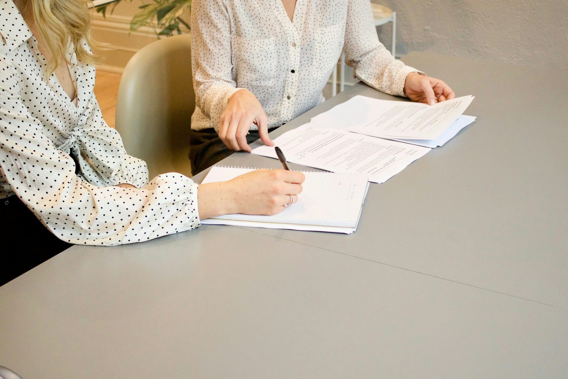 Two women talking on a table