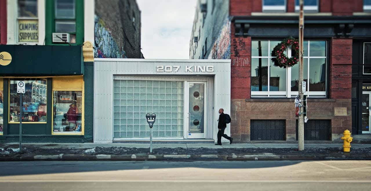 A man walking past a store with white paint