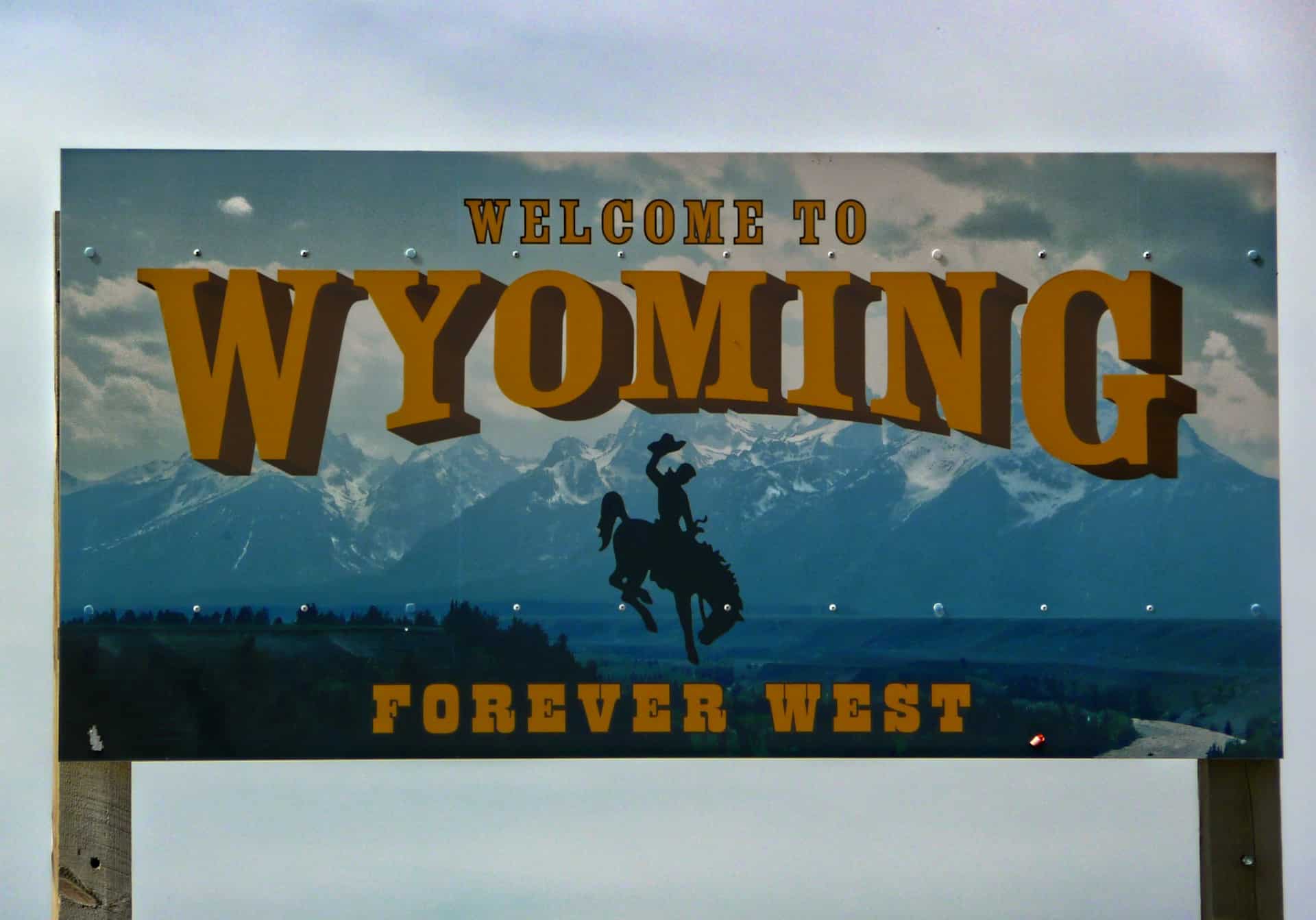 A sign that says “Welcome to Wyoming, Forever West”
