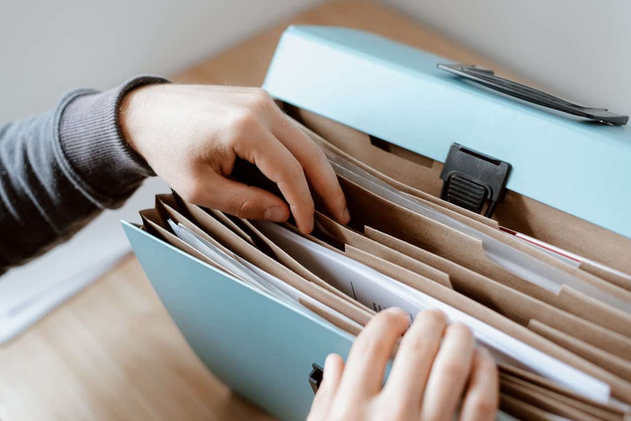 A person getting documents from a folder