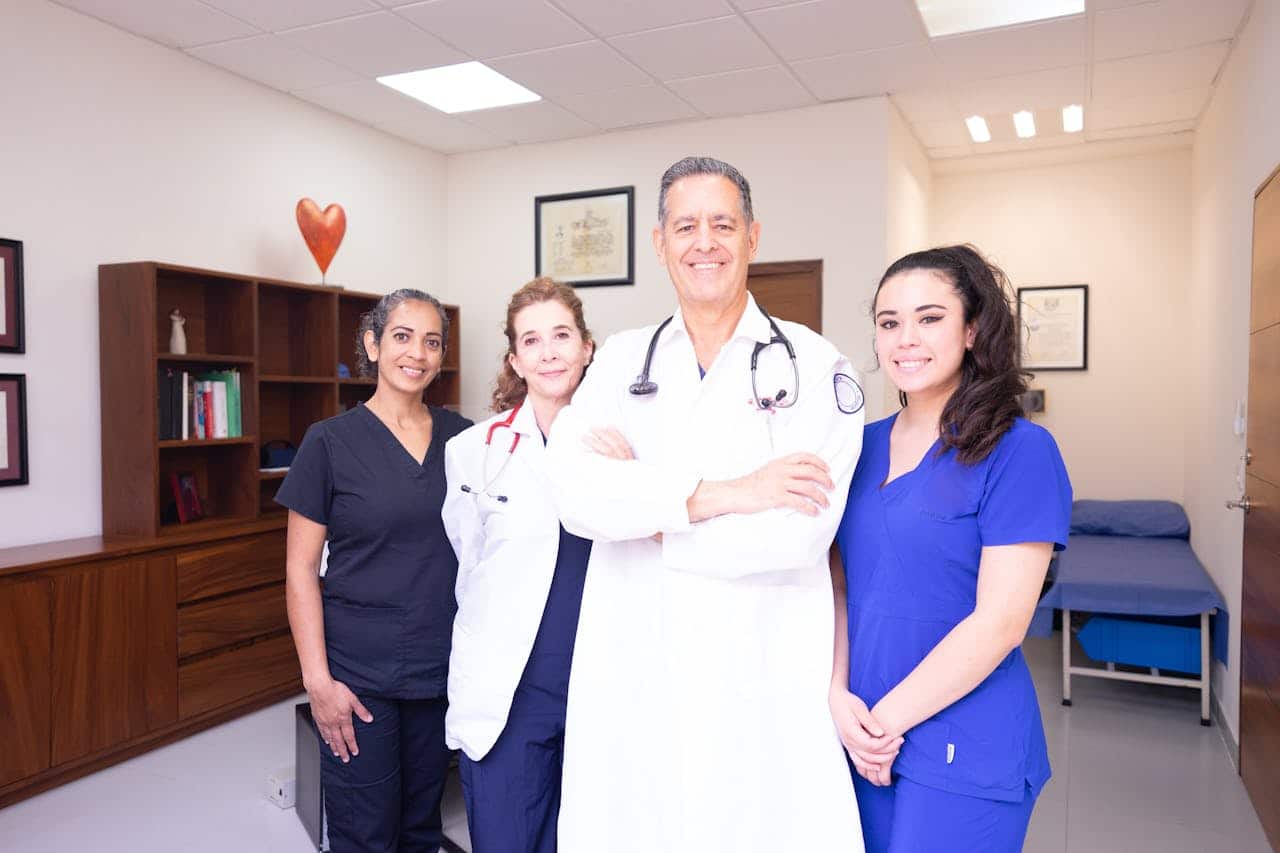 Two doctors and two female nurses inside a medical clinic