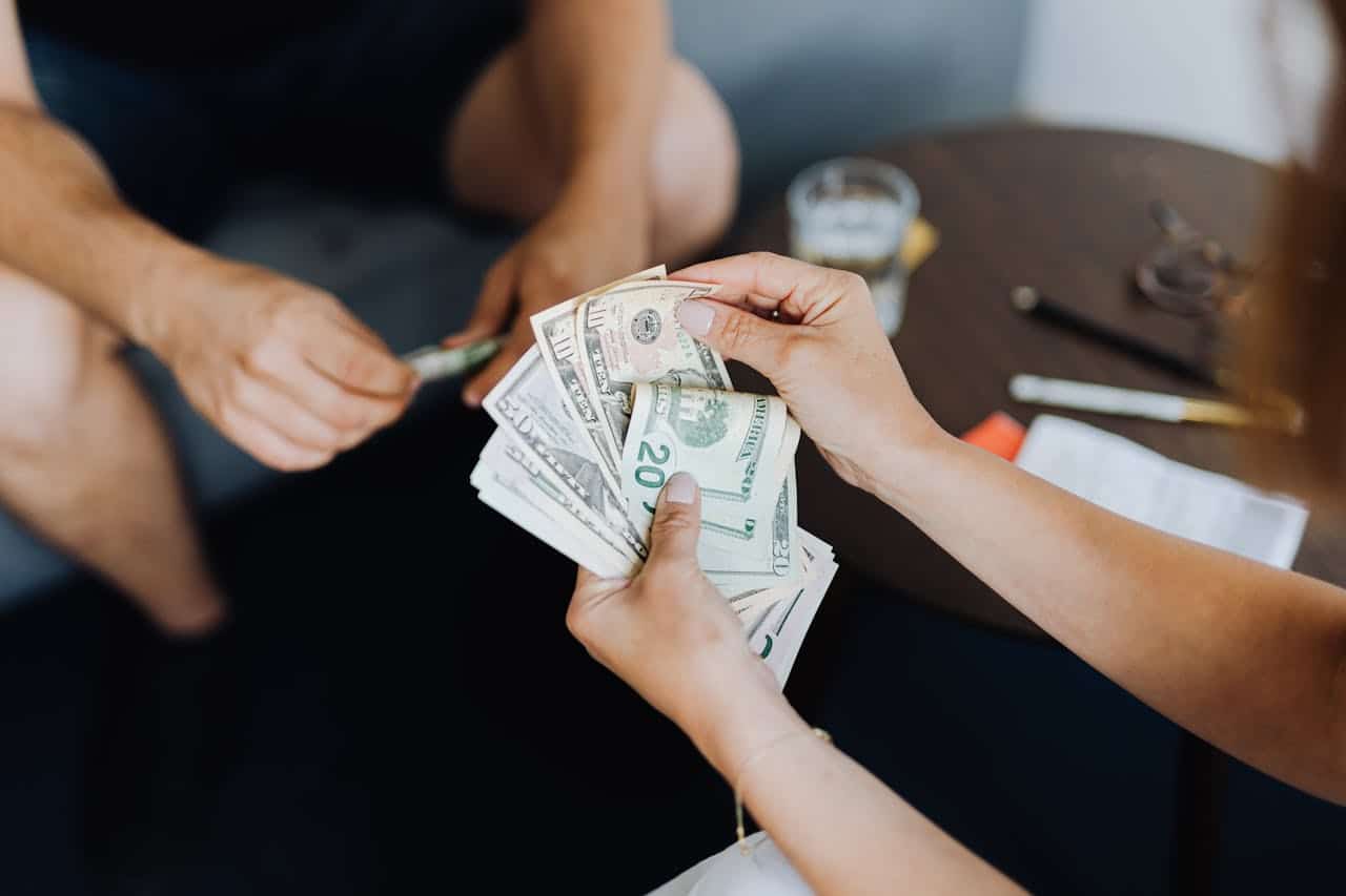 Close-up of a person counting dollar bills