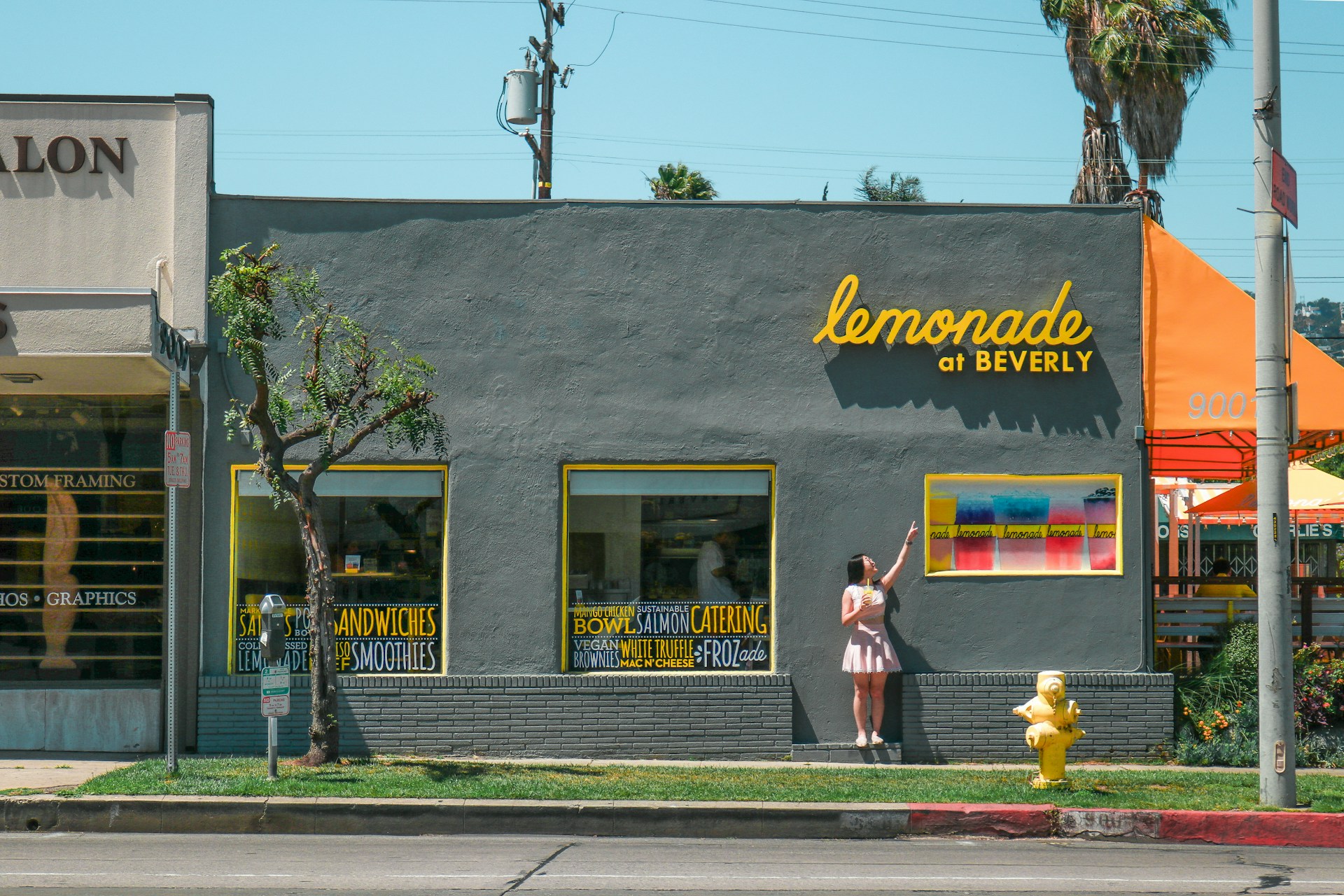 A girl standing in front of a restaurant