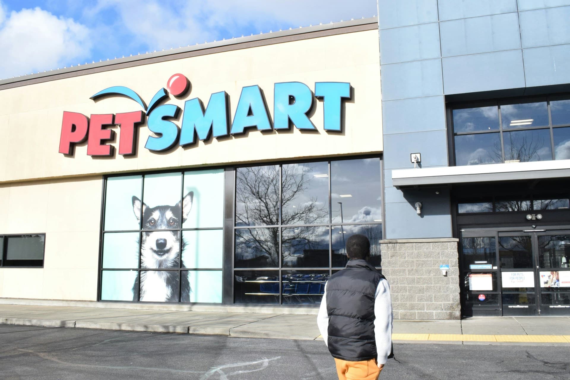 A man walking toward a store named PetSmart