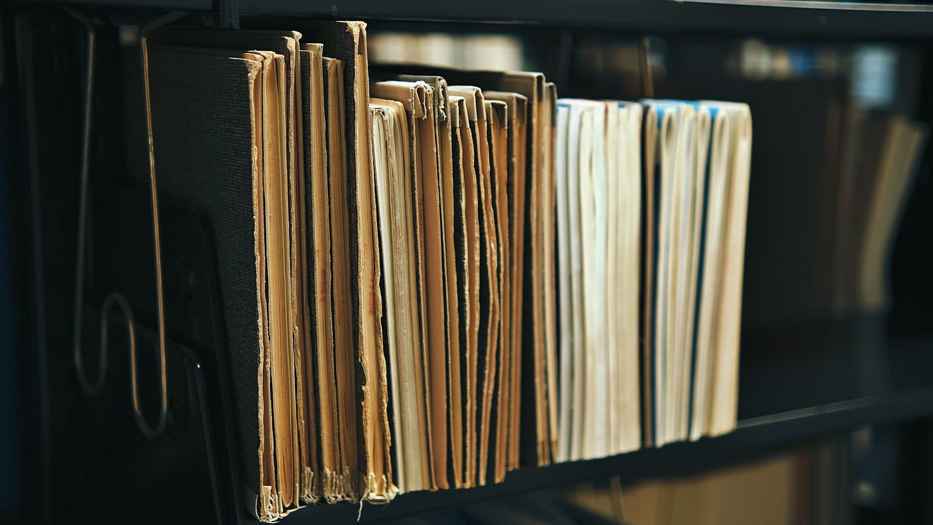 A shelf with old documents and books