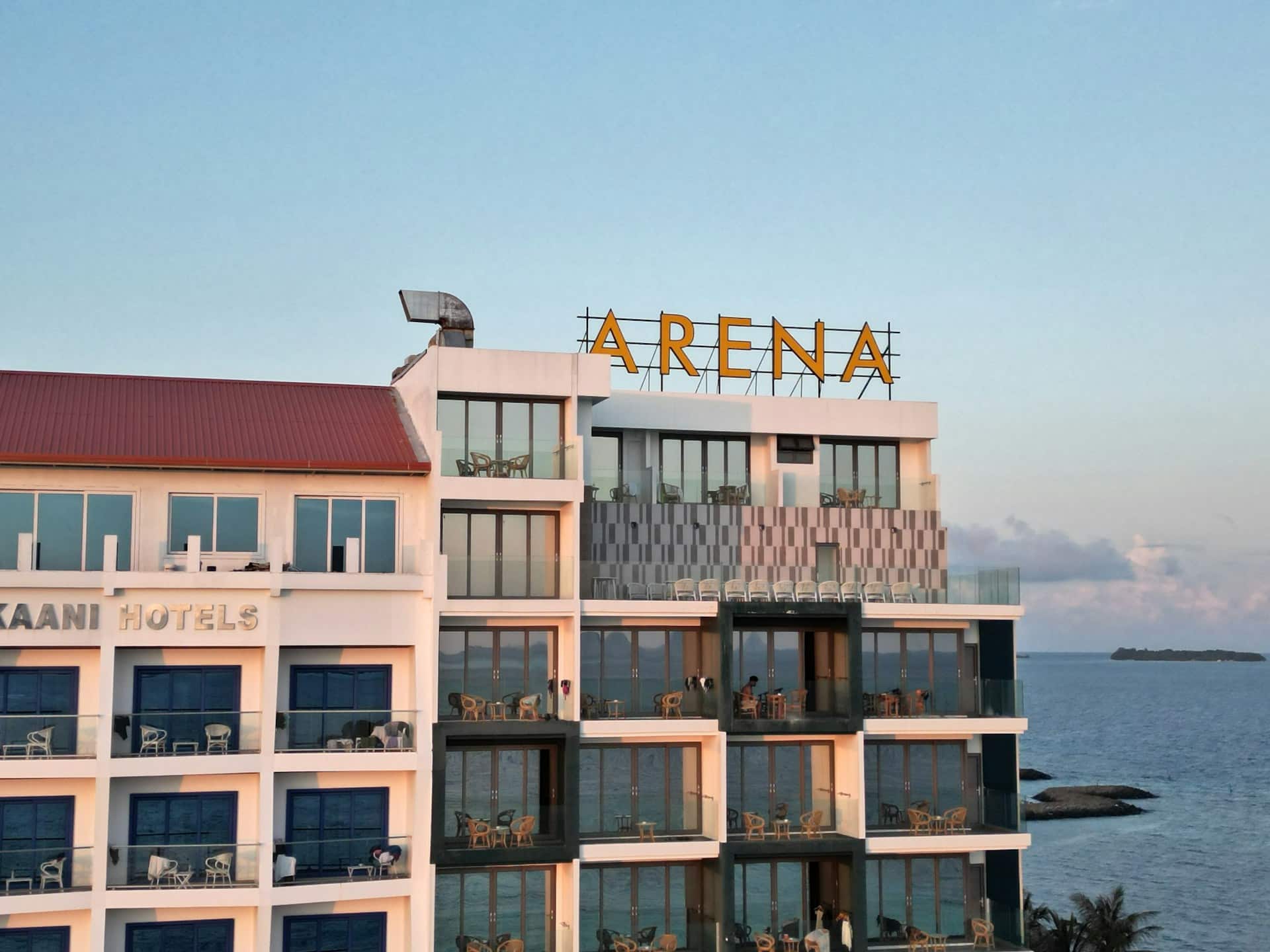 A high-rise building with the word arena on top of it