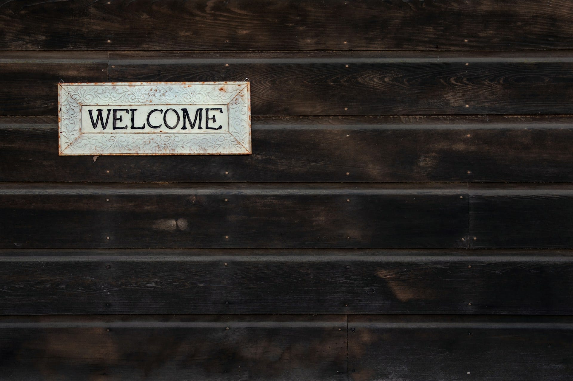 Welcome board on wooden wall