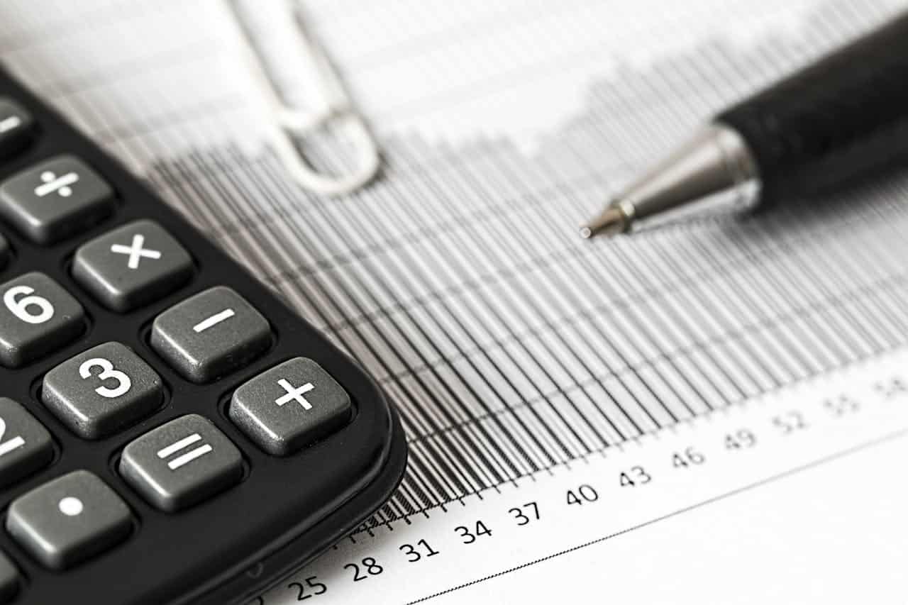 Calculator and Pen on the Table