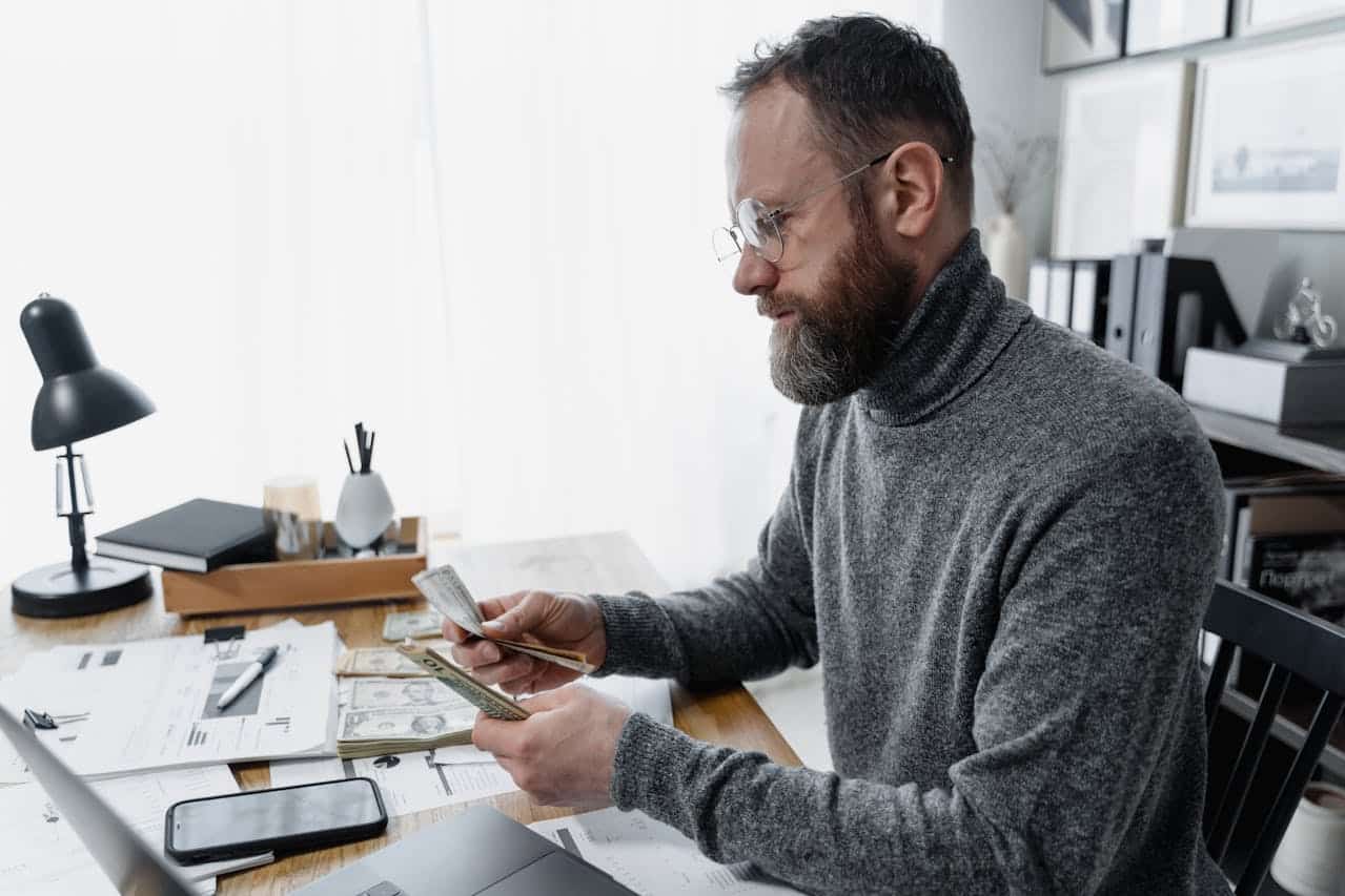 Bearded man counting money