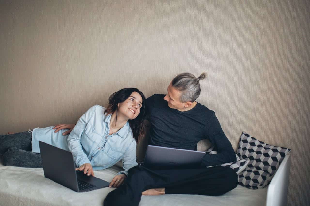 A man and a woman with laptops