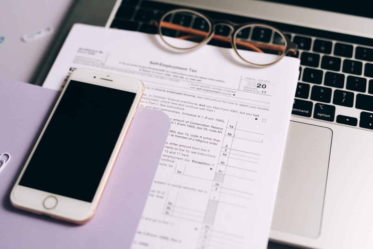 Close-up of a smartphone and a self-employment tax return