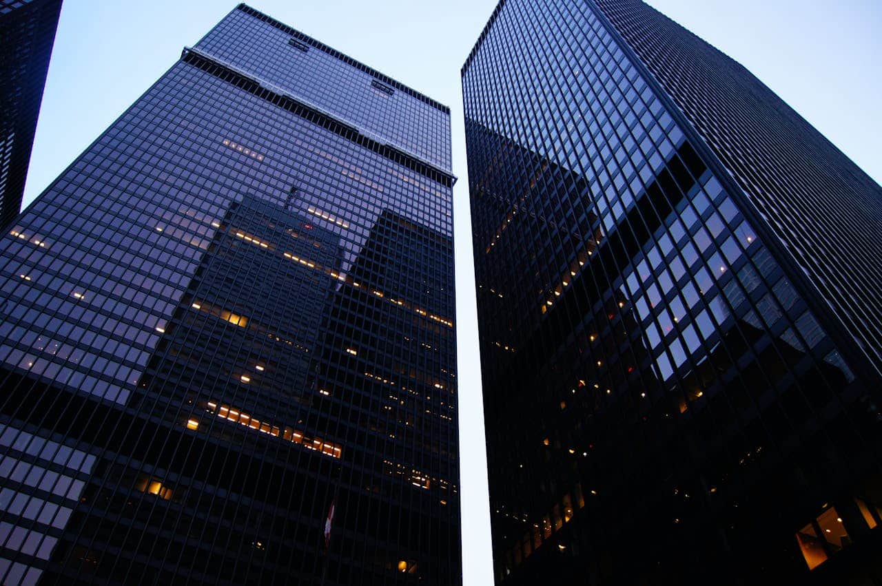 Two high-rise buildings with some lights turned on