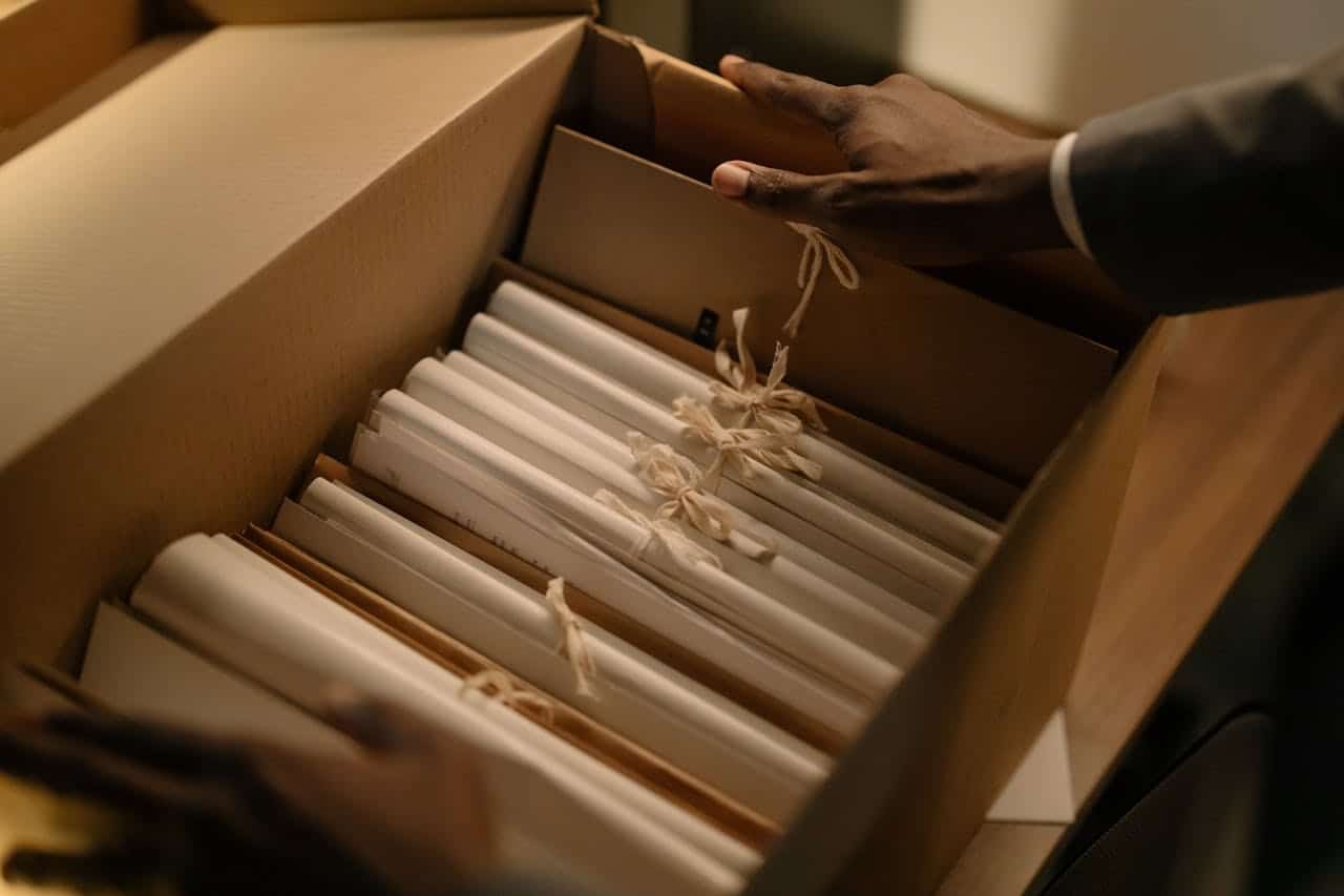 A cardboard box with folders inside it