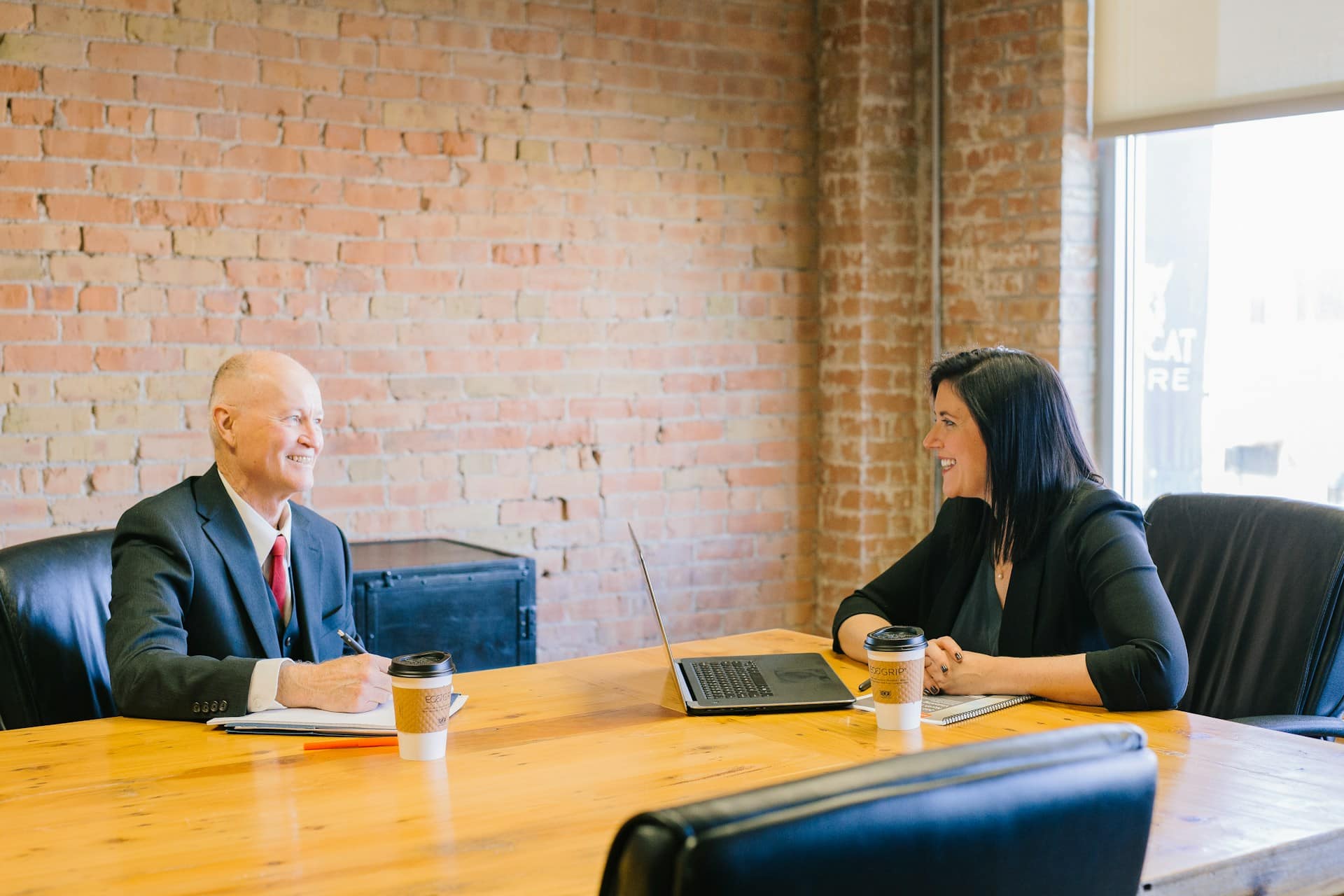 Two professionals in a meeting room