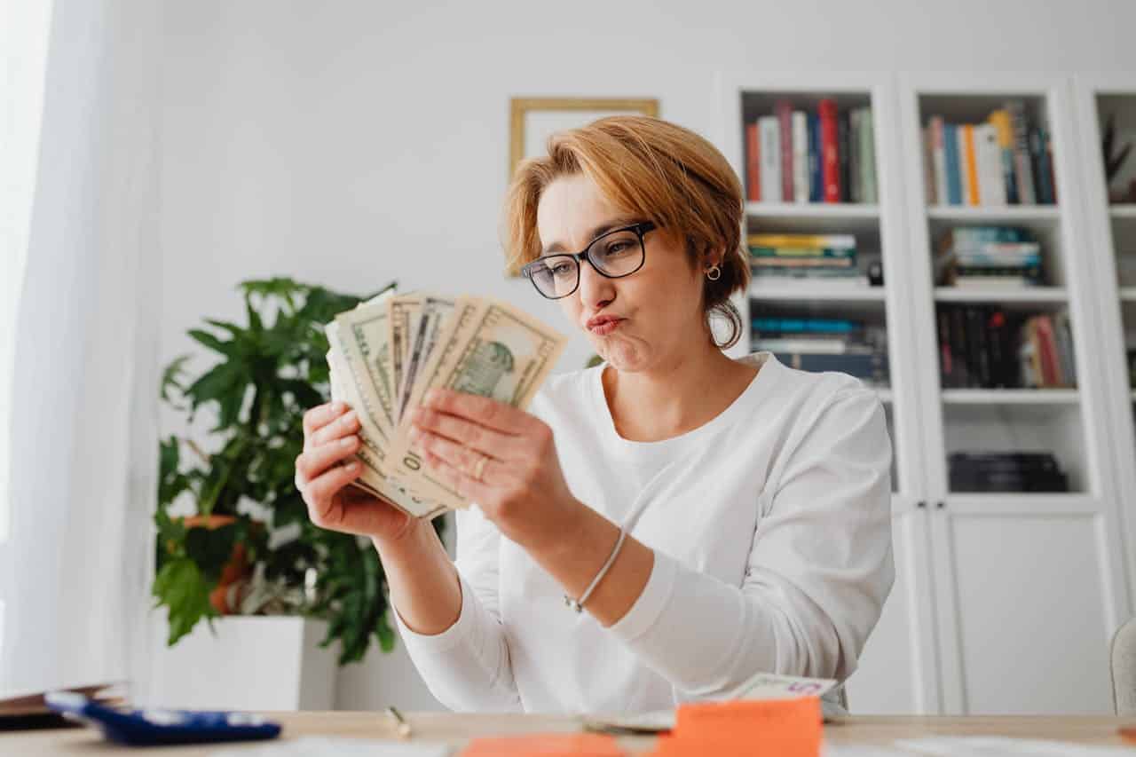 A happy woman with cash in hand
