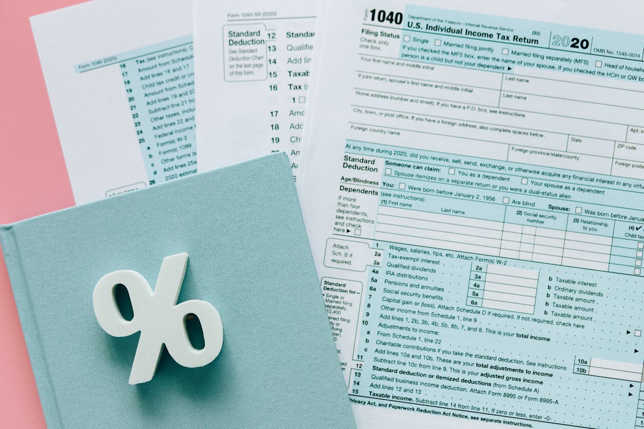 A close-up of a notebook and tax forms