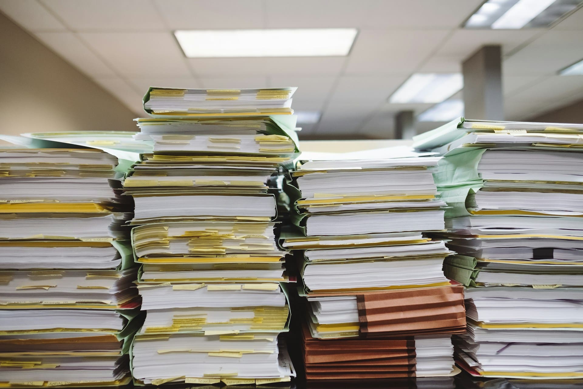 Four stacks of papers on a table