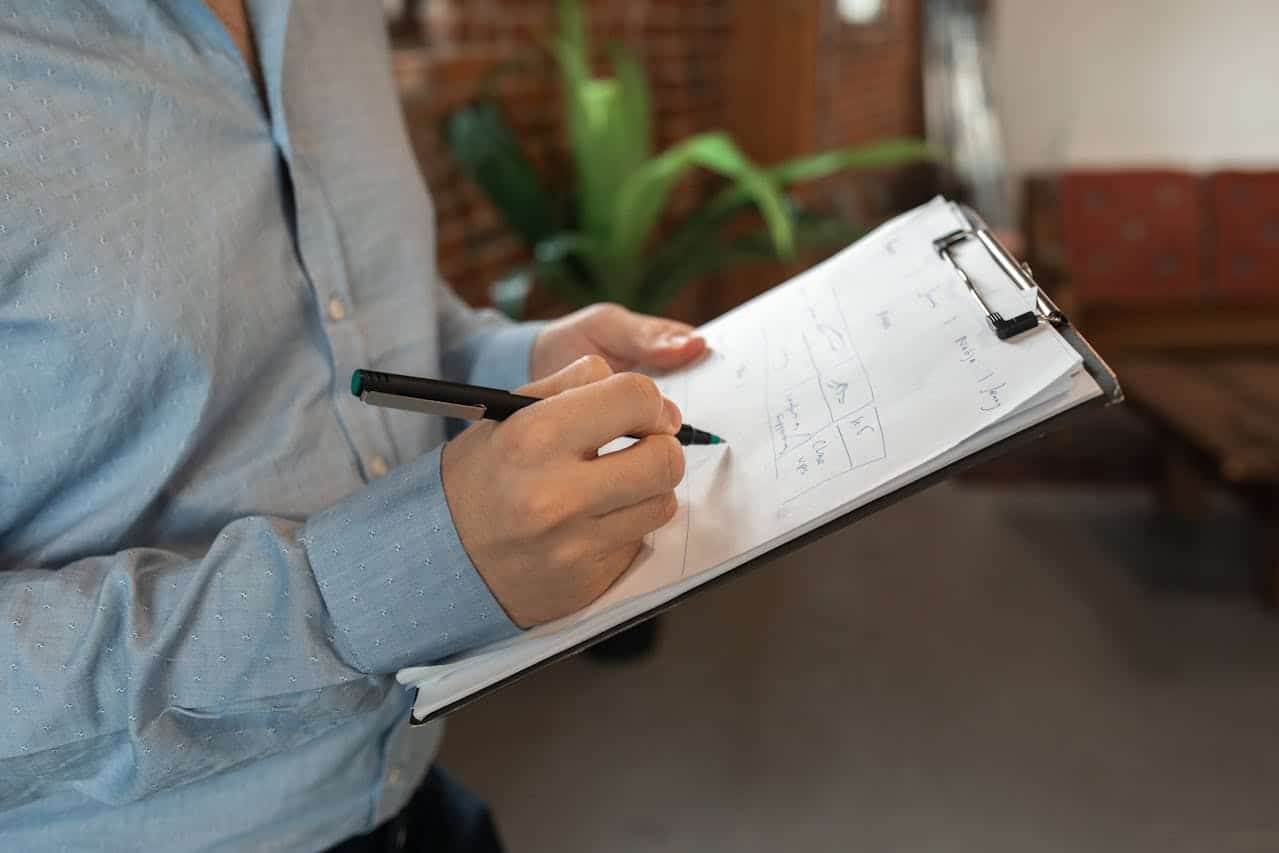 A man writing on a clipboard