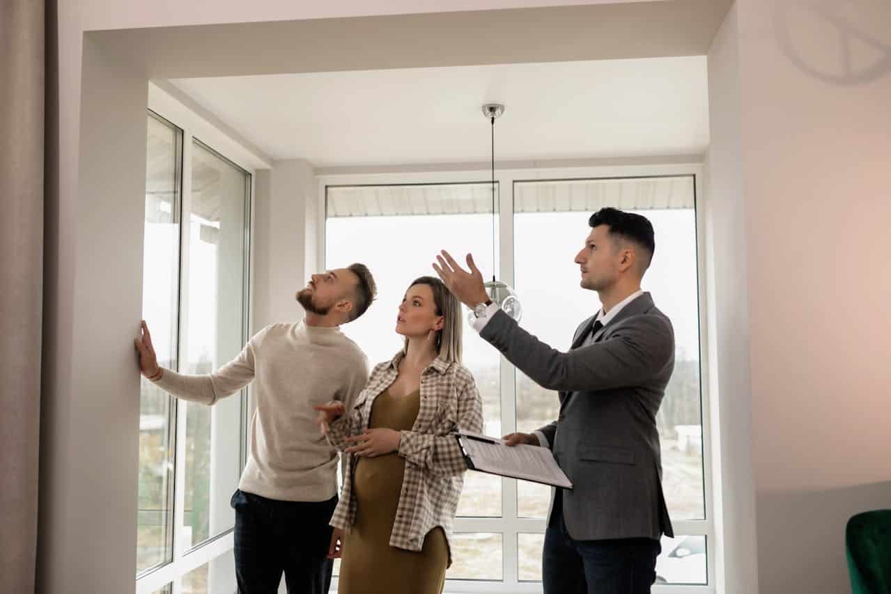 A couple touring a house with a real estate agent