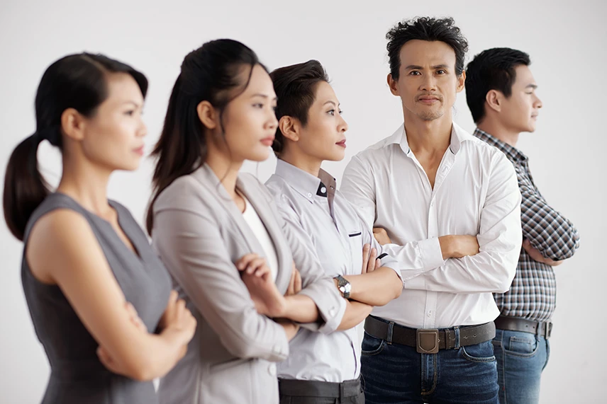 Group of business professionals with confident and folded arms.