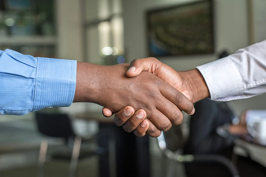 Close-up top view of a handshake, symbolizing agreement and partnership.