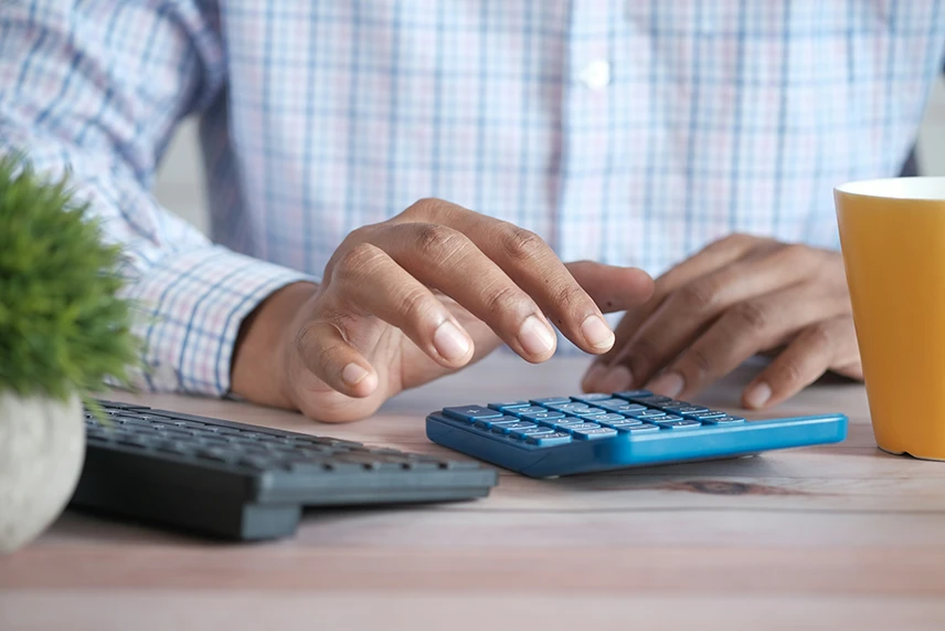 A man computing tax using a calculator